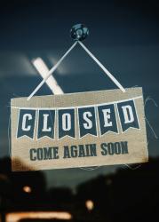 Image of closed sign in business window