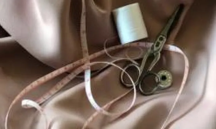 Image of alterations tools and notions laid upon fabric