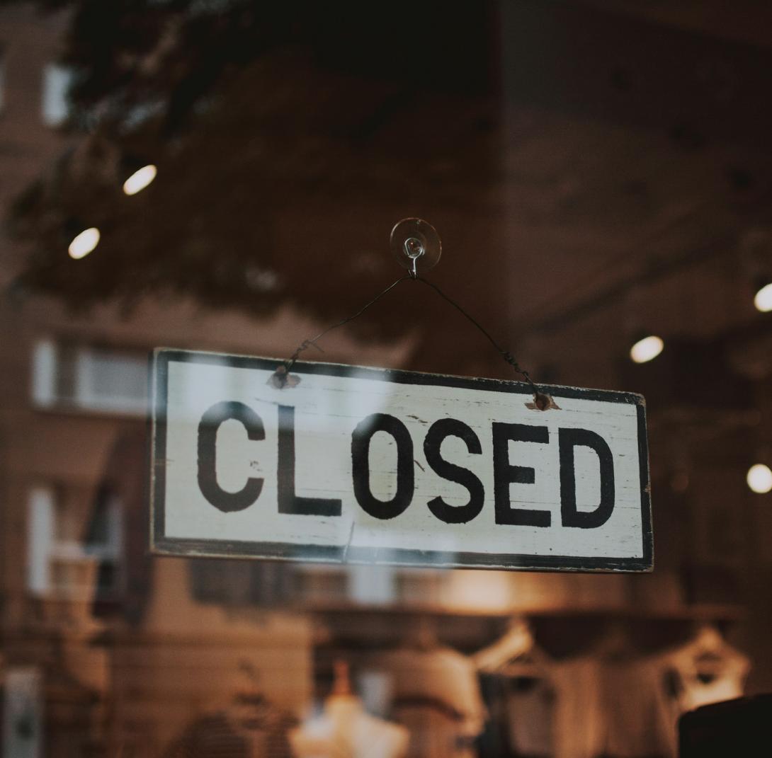 Black and white closed sign in business door